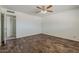 Spacious bedroom features stylish wood-look floors and a modern ceiling fan at 10655 E Broadway Rd, Mesa, AZ 85208