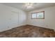 Bright bedroom featuring wood-look floors, a ceiling fan, and a closet at 10655 E Broadway Rd, Mesa, AZ 85208