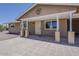 Charming home featuring a cozy covered patio and low-maintenance desert landscaping at 10655 E Broadway Rd, Mesa, AZ 85208