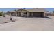 Well-maintained single-story home with covered porch, carport, and easy-care landscaping at 10655 E Broadway Rd, Mesa, AZ 85208