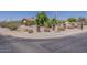 Well-maintained desert landscaping adds charm to the front of the house on a corner lot at 10655 E Broadway Rd, Mesa, AZ 85208