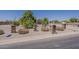 Desert landscaping, featuring gravel and native plants, surrounds the property at 10655 E Broadway Rd, Mesa, AZ 85208