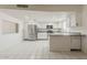 Bright kitchen with stainless steel appliances, white cabinets, and modern tile flooring at 10655 E Broadway Rd, Mesa, AZ 85208