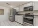 Kitchen with stainless steel appliances and white cabinets offer modern convenience at 10655 E Broadway Rd, Mesa, AZ 85208