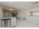 Open-concept living room and kitchen layout with a brick fireplace and tile flooring at 10655 E Broadway Rd, Mesa, AZ 85208