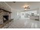 Open concept living room with brick fireplace flowing into the kitchen at 10655 E Broadway Rd, Mesa, AZ 85208