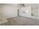 Comfortable living room with carpet, ceiling fan, and an open view of the updated kitchen at 10655 E Broadway Rd, Mesa, AZ 85208