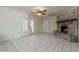 Spacious living room with a brick fireplace, white walls, and tile flooring at 10655 E Broadway Rd, Mesa, AZ 85208