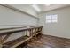 Work room with laminated floor, peg board and two work benches at 10655 E Broadway Rd, Mesa, AZ 85208