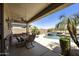 Covered patio with a pool, outdoor seating and desert landscaping at 1141 W Stephanie Ln, San Tan Valley, AZ 85143