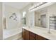 Bright bathroom featuring a soaking tub and double vanity with a large mirror at 1141 W Stephanie Ln, San Tan Valley, AZ 85143