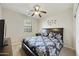 Cozy bedroom with ceiling fan, neutral walls, and plush carpeting at 1141 W Stephanie Ln, San Tan Valley, AZ 85143