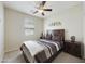 Cozy bedroom featuring a ceiling fan, window, and a comfortable bed with two nightstands at 1141 W Stephanie Ln, San Tan Valley, AZ 85143