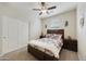 Inviting bedroom featuring a ceiling fan, window, and a comfortable bed with two nightstands at 1141 W Stephanie Ln, San Tan Valley, AZ 85143