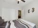 Relaxing bedroom with a ceiling fan, closet, and comfortable striped bedding at 1141 W Stephanie Ln, San Tan Valley, AZ 85143