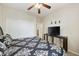 Comfortable bedroom with ceiling fan, TV, closet, and black and white patterned bedding at 1141 W Stephanie Ln, San Tan Valley, AZ 85143