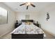 Comfortable primary bedroom with a ceiling fan, window, and comfortable bed at 1141 W Stephanie Ln, San Tan Valley, AZ 85143