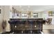 Open kitchen design features stone accent wall, granite countertops, and seating for four at the breakfast bar at 1141 W Stephanie Ln, San Tan Valley, AZ 85143