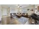 Inviting living room with a large sectional sofa, hardwood floors, and plenty of natural light at 1141 W Stephanie Ln, San Tan Valley, AZ 85143