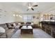 Inviting living room with a large sectional sofa, hardwood floors, and open concept kitchen at 1141 W Stephanie Ln, San Tan Valley, AZ 85143
