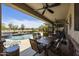 Outdoor patio with ceiling fans, dining table, and chairs overlooking a pool at 1141 W Stephanie Ln, San Tan Valley, AZ 85143