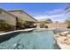 Stunning pool area with rock waterfall, hot tub, and mature landscaping at 1141 W Stephanie Ln, San Tan Valley, AZ 85143