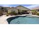 Backyard pool with adjacent outdoor kitchen and desert landscaping at 1141 W Stephanie Ln, San Tan Valley, AZ 85143