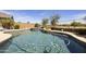 Sparkling pool with rock waterfall feature and desert landscaping in a private backyard at 1141 W Stephanie Ln, San Tan Valley, AZ 85143
