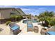 Resort-style backyard with a large pool, spa, and lush landscaping at 1141 W Stephanie Ln, San Tan Valley, AZ 85143
