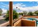 A scenic view from the balcony overlooks the community pool and desert landscape at 11640 N 51St Ave # 211, Glendale, AZ 85304