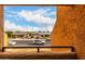 Balcony view showcases a residential street with single-Gathering houses and blue sky at 11640 N 51St Ave # 211, Glendale, AZ 85304