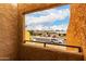 View from balcony shows tree-lined street and neighborhood houses at 11640 N 51St Ave # 211, Glendale, AZ 85304