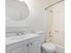 Bathroom features a neutral vanity, white sink, and shower over tub combo at 11640 N 51St Ave # 211, Glendale, AZ 85304