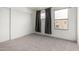Bedroom with a sliding door closet, carpet, and window with curtains at 11640 N 51St Ave # 211, Glendale, AZ 85304