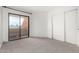Bedroom features new carpet and large sliding glass door leading to a patio at 11640 N 51St Ave # 211, Glendale, AZ 85304