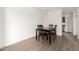 Dining area featuring a table with four chairs and light-colored wood floors at 11640 N 51St Ave # 211, Glendale, AZ 85304