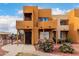 Inviting two-story exterior showcases a private balcony, decorative rock and lush flowering bushes at 11640 N 51St Ave # 211, Glendale, AZ 85304