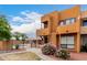 Attractive exterior view showcases balcony, decorative rock, bushes and a community pool at 11640 N 51St Ave # 211, Glendale, AZ 85304