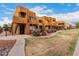A row of exterior units features balconies and decorative landscaping with flowering bushes at 11640 N 51St Ave # 211, Glendale, AZ 85304