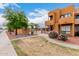 Beautiful exterior view shows balconies, attractive landscaping, decorative rock and community pool at 11640 N 51St Ave # 211, Glendale, AZ 85304