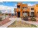 Well-maintained building exterior with landscaped yard, decorative rock, and a community pool beyond at 11640 N 51St Ave # 211, Glendale, AZ 85304