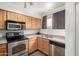 Efficient kitchen design with stainless steel appliances and light wood cabinetry at 11640 N 51St Ave # 211, Glendale, AZ 85304