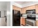 Kitchen with stainless steel appliances and light wood cabinetry at 11640 N 51St Ave # 211, Glendale, AZ 85304