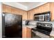 Kitchen with stainless steel microwave and oven with light wood cabinetry at 11640 N 51St Ave # 211, Glendale, AZ 85304