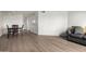 Open concept living space with dining area, sofa, wood-look floors and ample light at 11640 N 51St Ave # 211, Glendale, AZ 85304