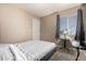 Neutral bedroom featuring carpet flooring, window with gray curtains, and a small table at 11841 W Laurel Ln, El Mirage, AZ 85335