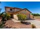 Charming two-story home with a well-maintained front yard, desert landscaping, and attached garage at 11841 W Laurel Ln, El Mirage, AZ 85335