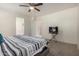 Relaxing bedroom with neutral carpet, TV on stand, and en-suite bathroom at 11841 W Laurel Ln, El Mirage, AZ 85335