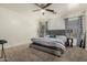 Spacious main bedroom featuring plush carpeting, neutral walls, and stylish curtains for a relaxing retreat at 11841 W Laurel Ln, El Mirage, AZ 85335