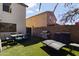 Backyard featuring an artificial lawn, grill, and an outdoor dining area at 12814 W Edgemont Ave, Avondale, AZ 85392